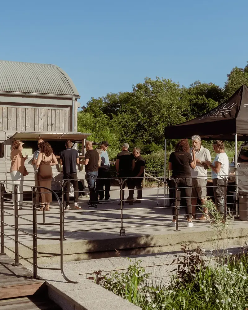 Guests on a drinks reception in The Courtyard at Everards Farm