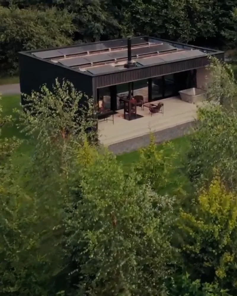 A timber lodge among birch woodland in the grounds of Everards Farm